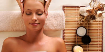 attractive female getting recreation massage of head High angle portrait of an attractive female getting recreation massage of head